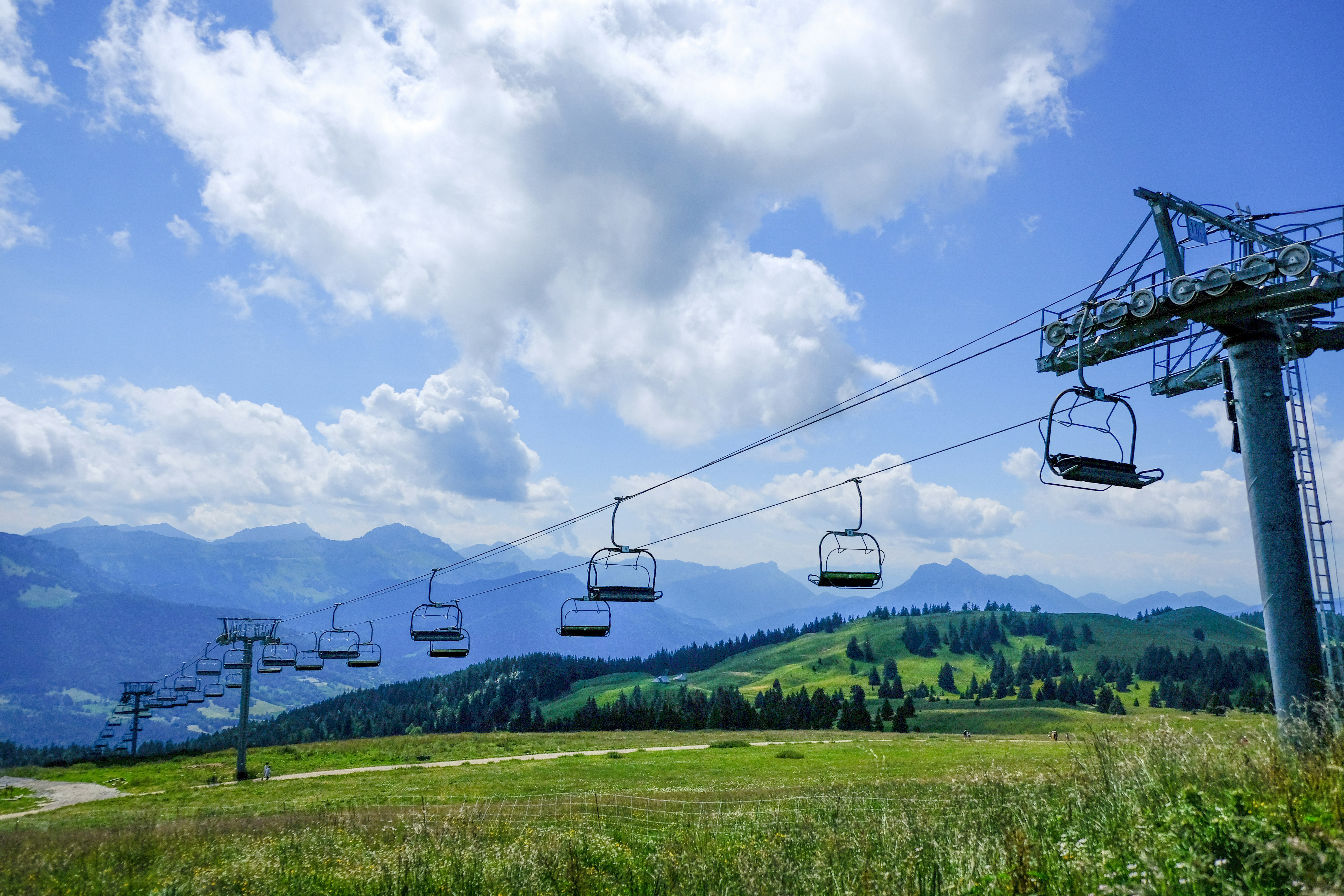 cable cars over green grass field during daytime